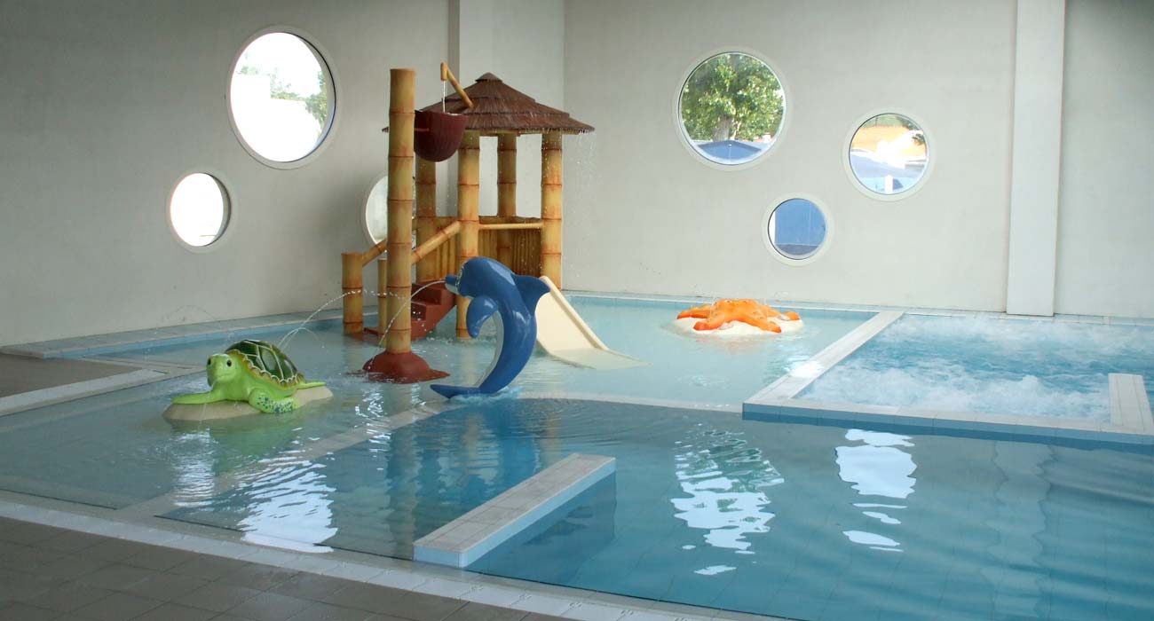 Playful swimming pool for children in the interior space of the campsite in Vendée