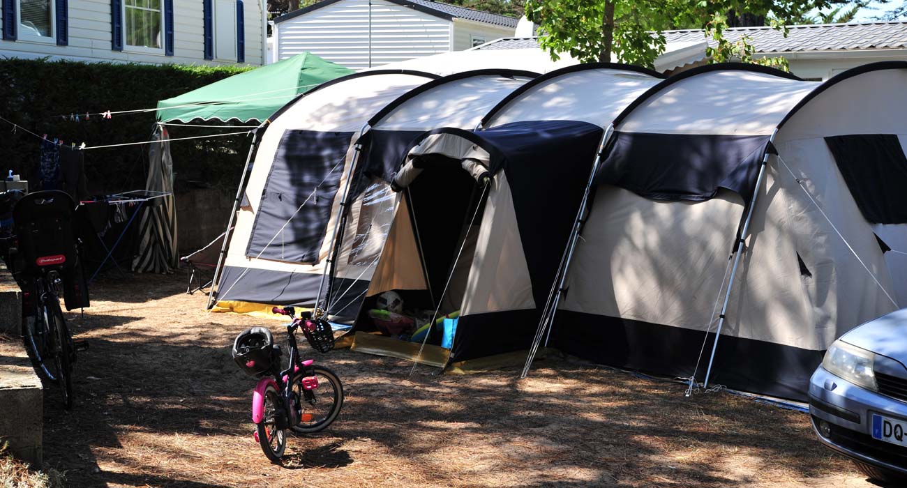 Fietsen en tenten op de paden van camping Clos des Pins aan zee in de Vendée