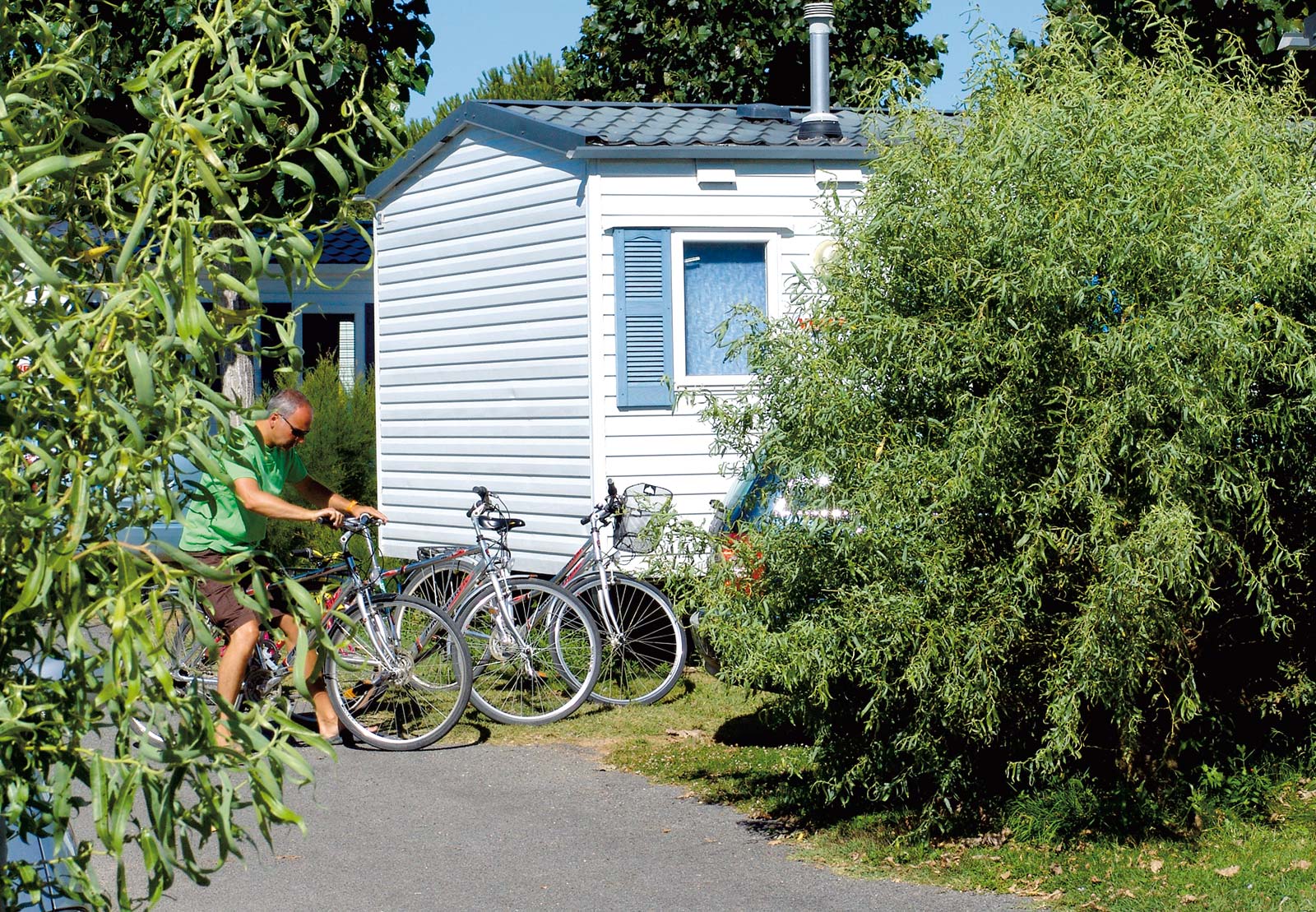 Bikes in front of a mobile home for rent in the campsite park in Saint-Hilaire in Vendée