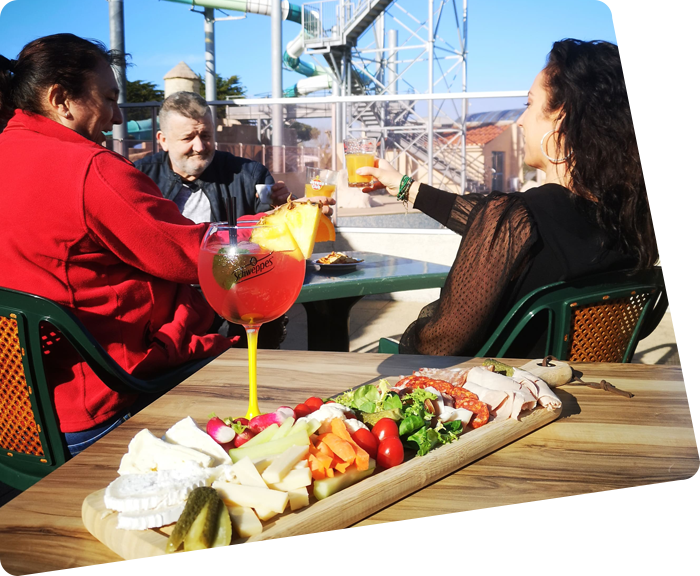 Dishes and cocktails on a table on the terrace of the campsite in Saint-Hilaire