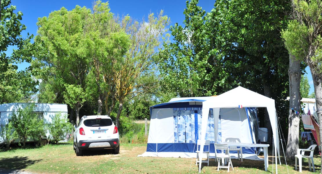 Tent and garden furniture on a campsite by the sea in Saint-Hilaire-de-Riez