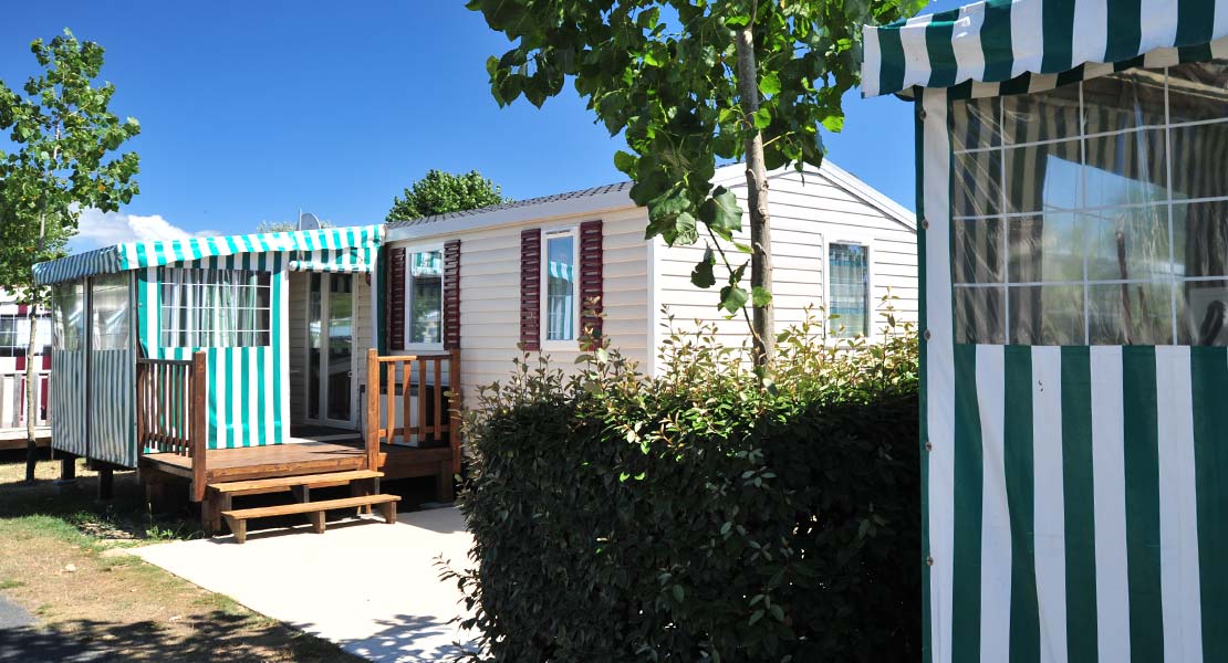 Mobil-home et haie dans le parc du camping La Plage en Vendée