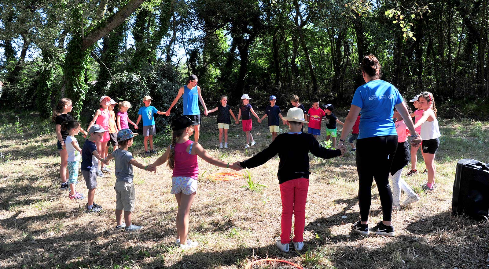 Children in a clearing with the children's club at La Prairie campsite in Saint-Hilaire