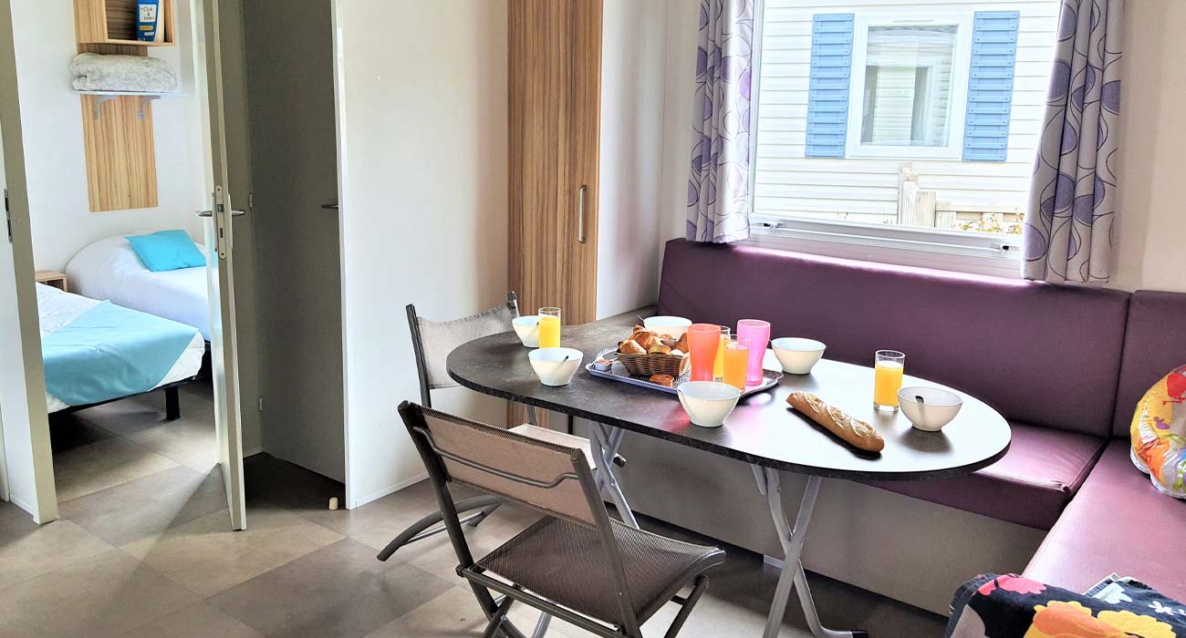 Table et canapés confortables dans un mobil-home en Vendée