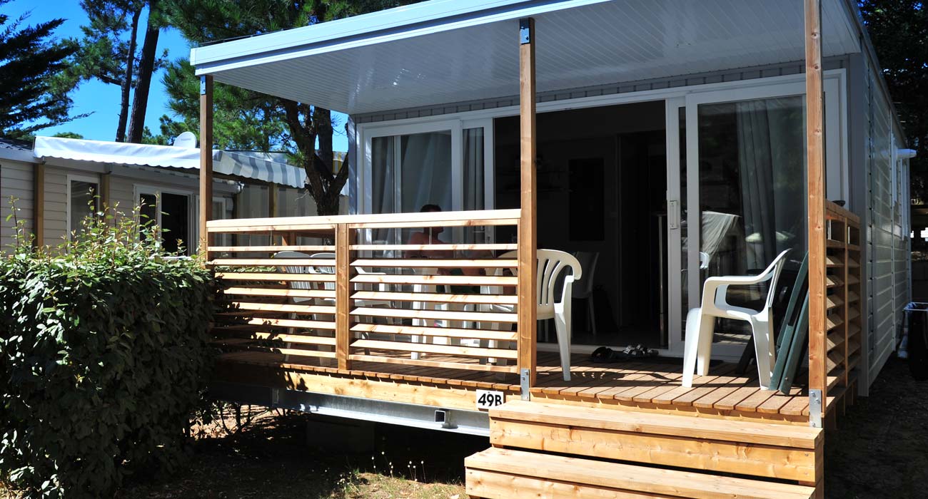 Covered wooden terrace at the campsite near the beaches in Saint-Hilaire 85 le Clos des Pins